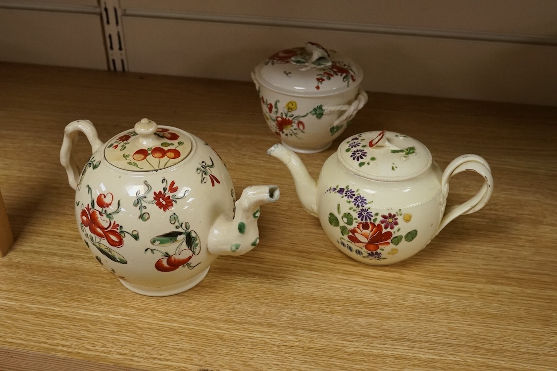 Two George III creamware teapots and a lidded sugar bowl, c.1780, largest 20cm wide